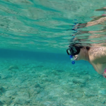 Woman snorkeling in pure water on Greek Islands
