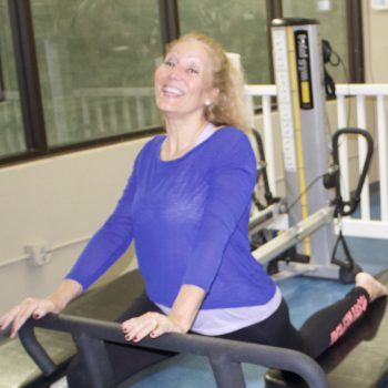 Two women on Total Gym machines in Total Body Pilates at Monroe County Southwest YMCA