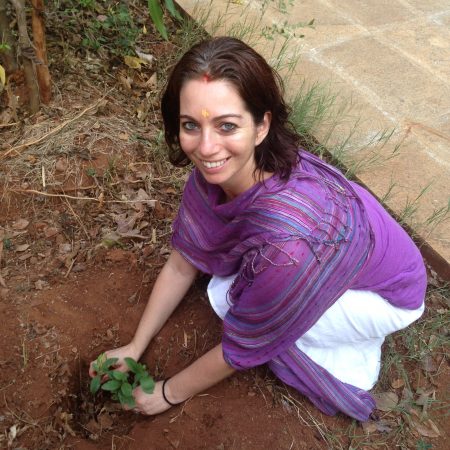 Yulia planting a neem tree at Vaidyagrama